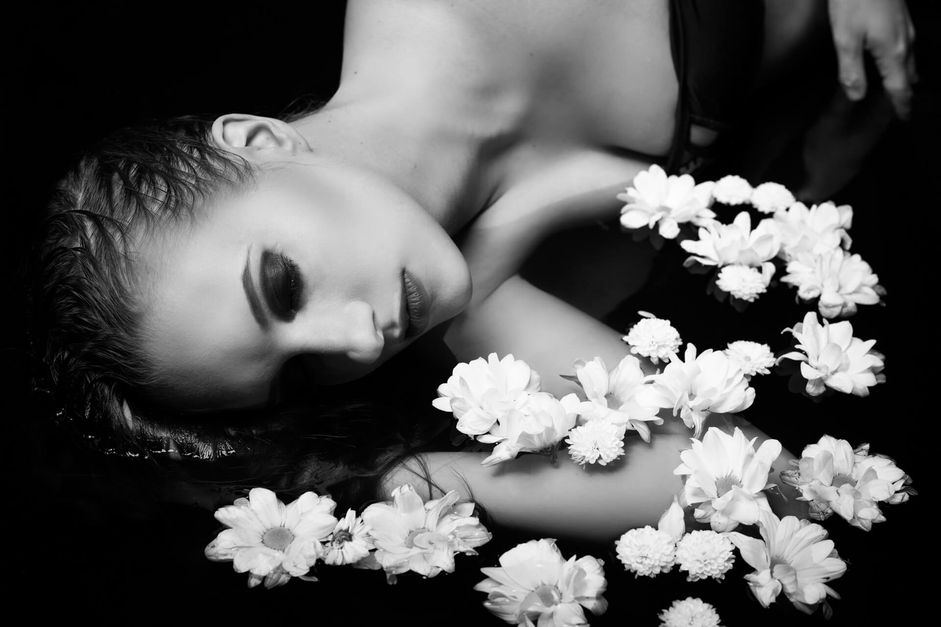 Dame im Wasser mit weißem Blumen